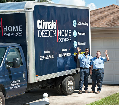 Climate design team mates standing by service truck