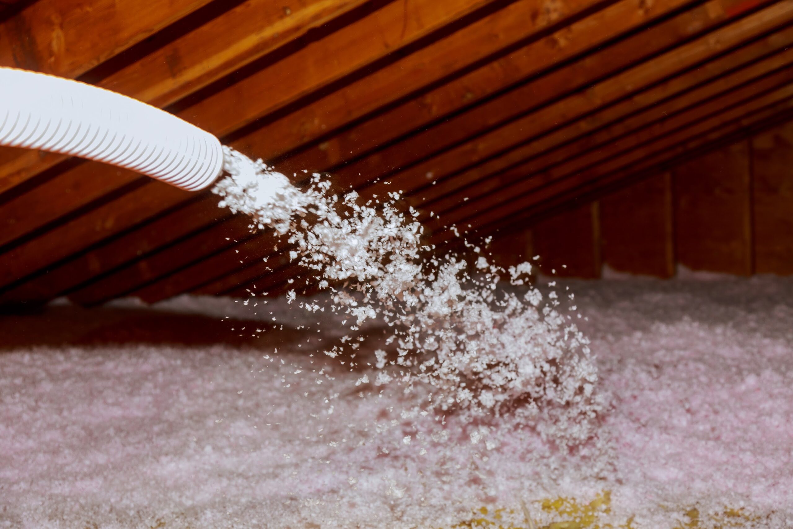Spraying Blown Fiberglass Insulation for roof technician spraying foam insulation